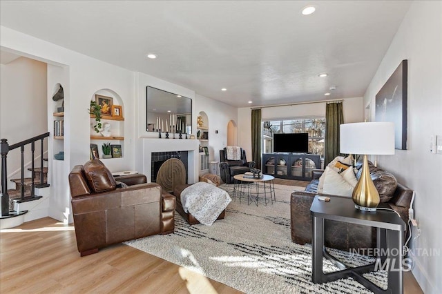 living room featuring a fireplace and light wood-type flooring