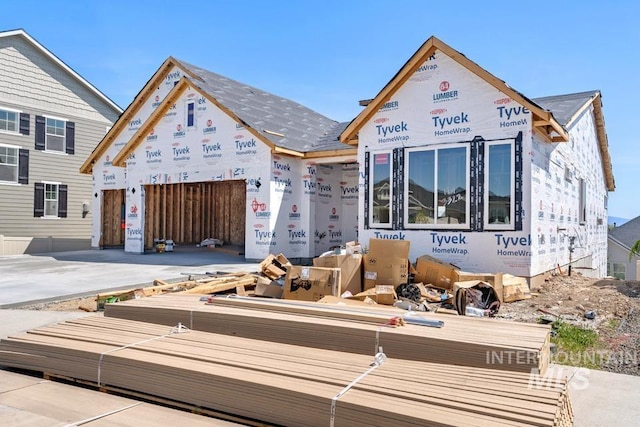 unfinished property with concrete driveway and a garage