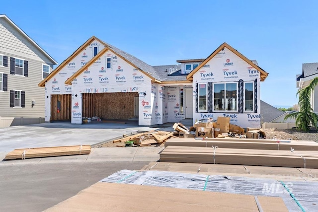 unfinished property with a garage and driveway