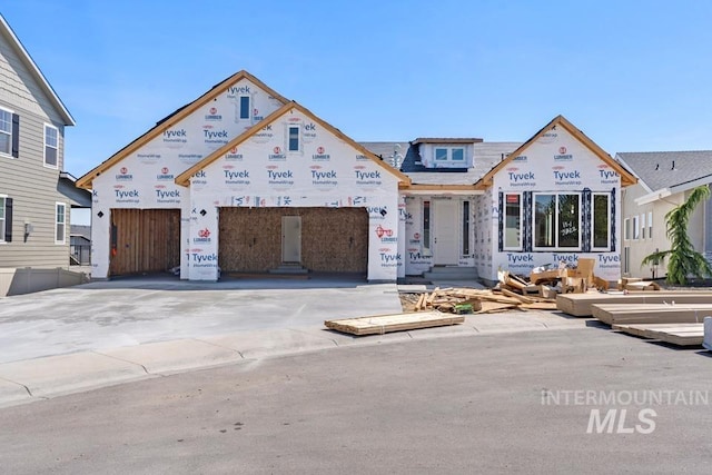 unfinished property featuring concrete driveway