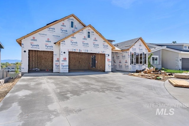 property in mid-construction featuring driveway