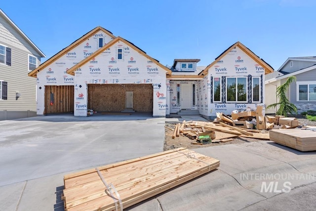 property under construction with concrete driveway
