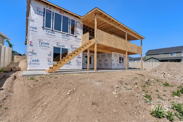 back of house featuring fence
