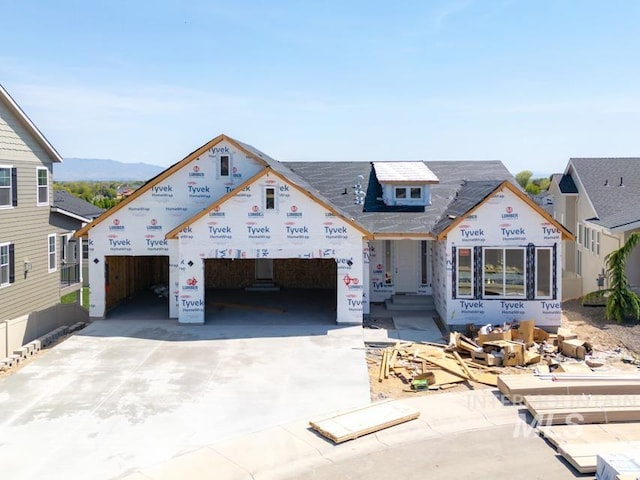 property under construction with concrete driveway and an attached garage