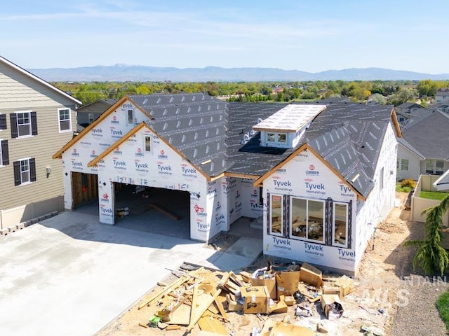 property under construction with a mountain view, driveway, and a garage
