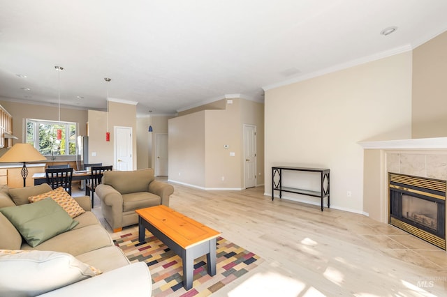 2072 N 28th St, Boise, ID 83702 - living room with ornamental molding, light wood-style flooring, a tile fireplace, baseboards, and recessed lighting