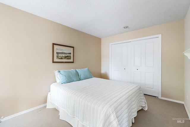 2072 N 28th St, Boise, ID 83702 - bedroom with light carpet, baseboards, a closet, and a textured ceiling