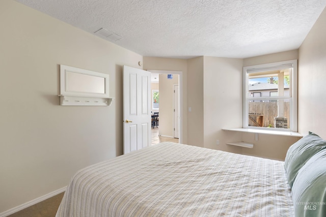 2072 N 28th St, Boise, ID 83702 - bedroom featuring baseboards, carpet flooring, multiple windows, and a textured ceiling