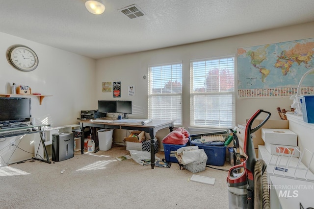 carpeted home office with a textured ceiling