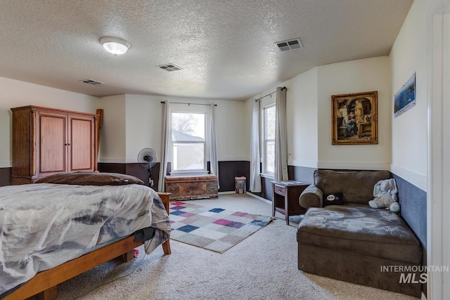 carpeted bedroom featuring a textured ceiling