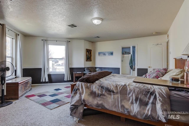 bedroom with carpet and a textured ceiling