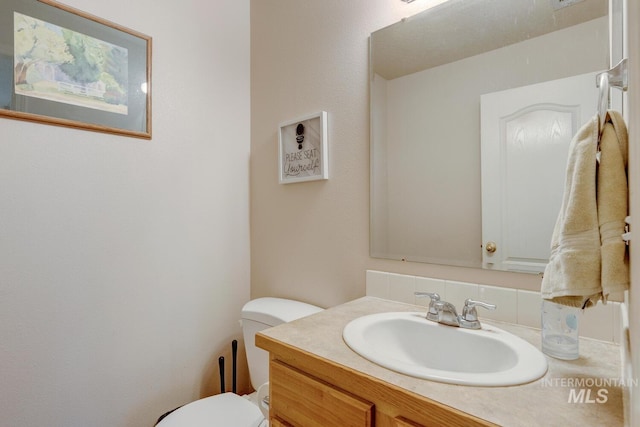 bathroom with vanity and toilet