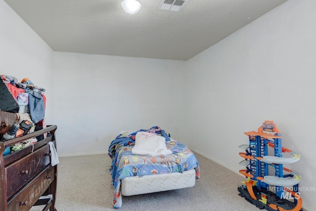 carpeted bedroom with a textured ceiling