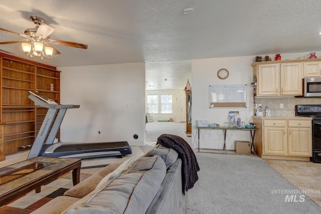 tiled living room with a textured ceiling and ceiling fan