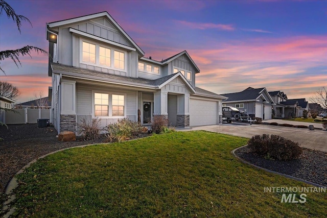 craftsman house with a lawn, cooling unit, and a garage