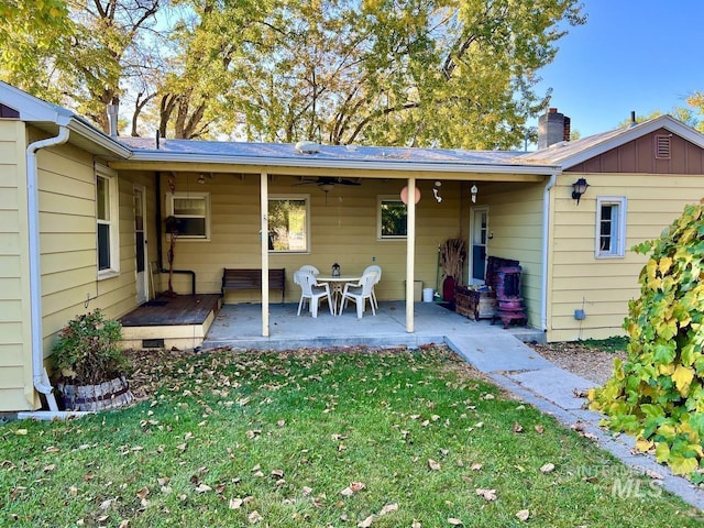 back of house featuring a patio area, ceiling fan, and a lawn