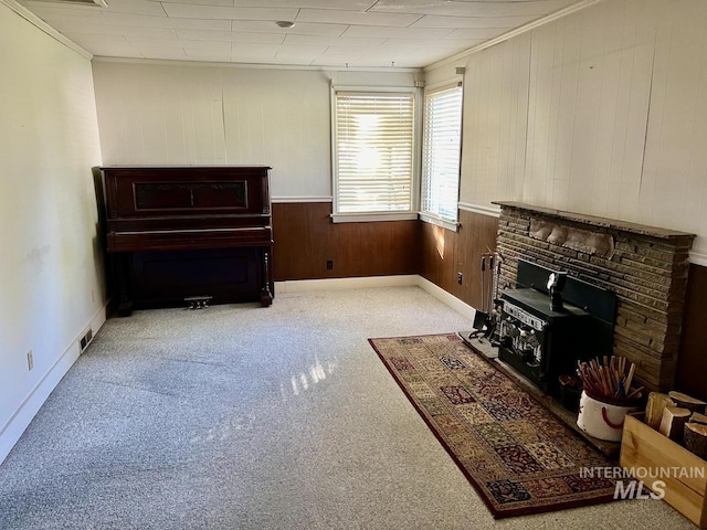 living room with light colored carpet, wooden walls, and crown molding