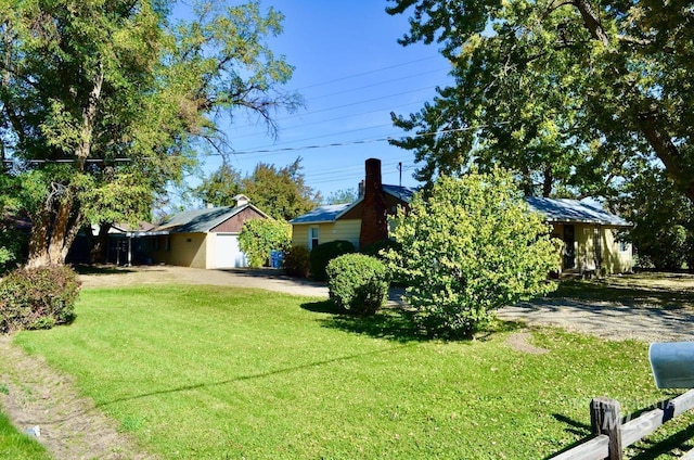 view of yard featuring an outbuilding and a garage