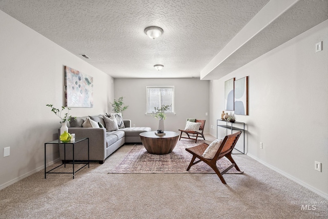 carpeted living room featuring baseboards, visible vents, and a textured ceiling