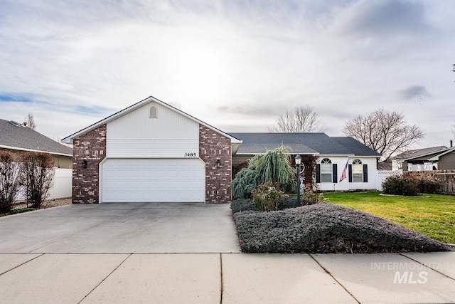 ranch-style house featuring brick siding, fence, concrete driveway, a front yard, and a garage