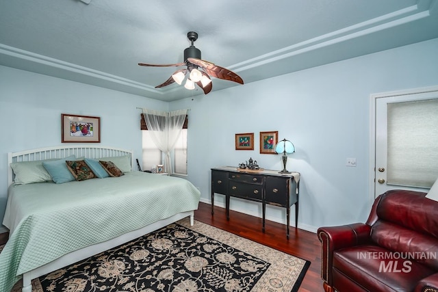 bedroom featuring a ceiling fan, baseboards, and wood finished floors