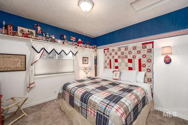 bedroom with baseboards, a textured ceiling, attic access, and carpet flooring