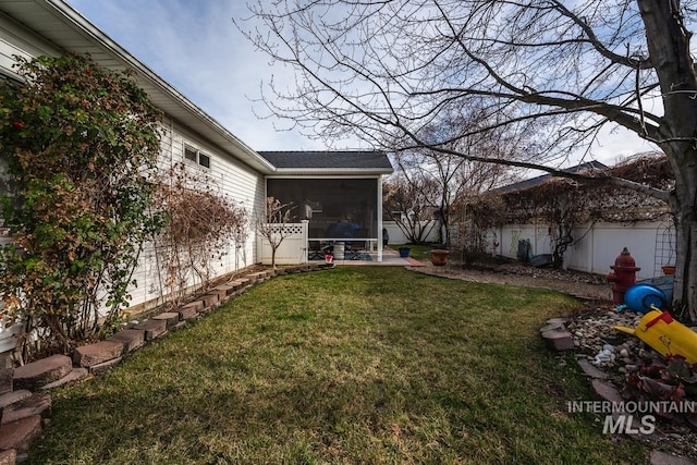 view of yard featuring a patio, a fenced backyard, and a sunroom