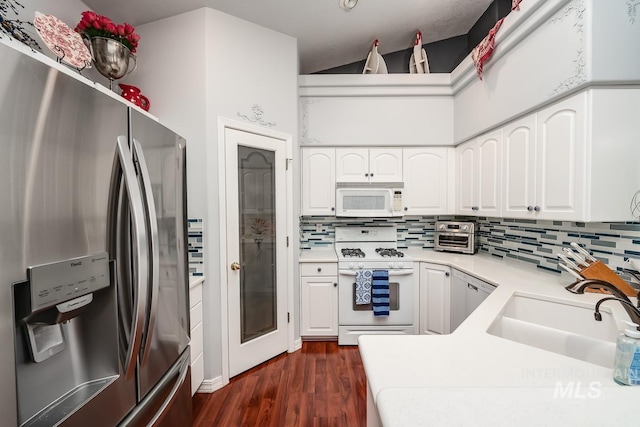 kitchen with white appliances, dark wood-type flooring, backsplash, and a sink