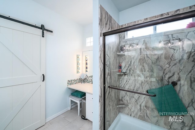 bathroom with a marble finish shower and baseboards