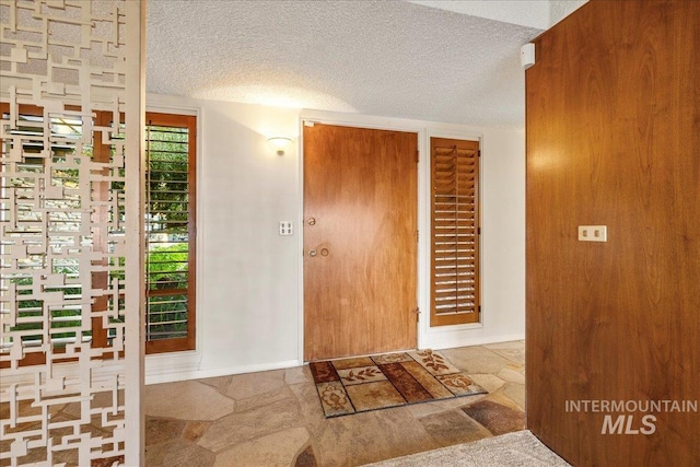 2401 Terrace Dr, Caldwell, ID 83605 - foyer entrance featuring a textured ceiling and stone finish floors