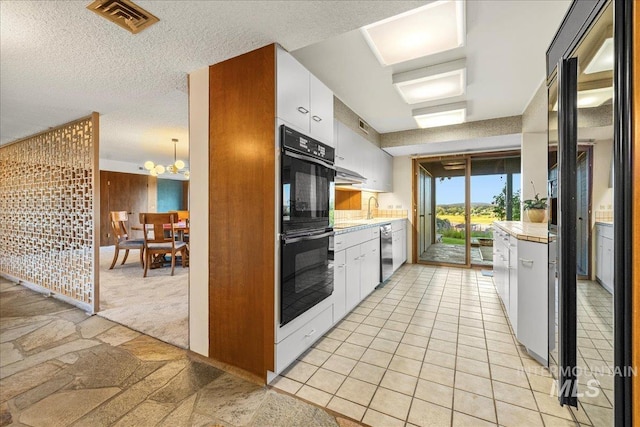 2401 Terrace Dr, Caldwell, ID 83605 - kitchen featuring light countertops, a chandelier, white cabinets, dishwasher, and a textured ceiling