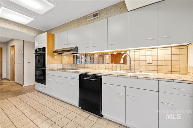 2401 Terrace Dr, Caldwell, ID 83605 - kitchen featuring black appliances, range hood, white cabinets, backsplash, and tile countertops