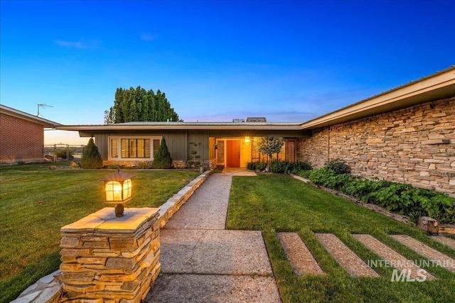 2401 Terrace Dr, Caldwell, ID 83605 - view of exterior entry featuring a lawn and stone siding