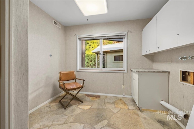 2401 Terrace Dr, Caldwell, ID 83605 - laundry room with cabinet space, light stone finish floors, and washer hookup