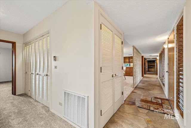 2401 Terrace Dr, Caldwell, ID 83605 - corridor with a textured ceiling and carpet floors