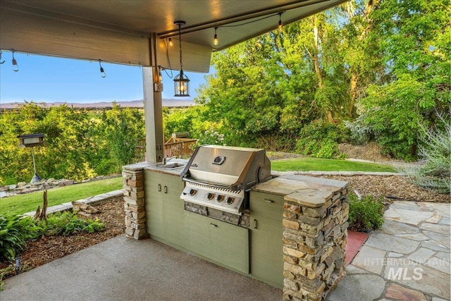 2401 Terrace Dr, Caldwell, ID 83605 - view of patio with an outdoor kitchen and a sink