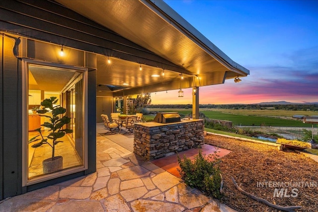 2401 Terrace Dr, Caldwell, ID 83605 - patio terrace at dusk featuring a patio area and exterior kitchen