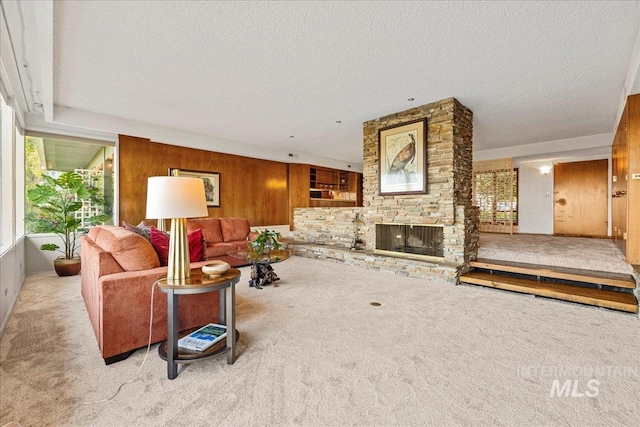 2401 Terrace Dr, Caldwell, ID 83605 - carpeted living room featuring healthy amount of natural light, a textured ceiling, a stone fireplace, and wood walls