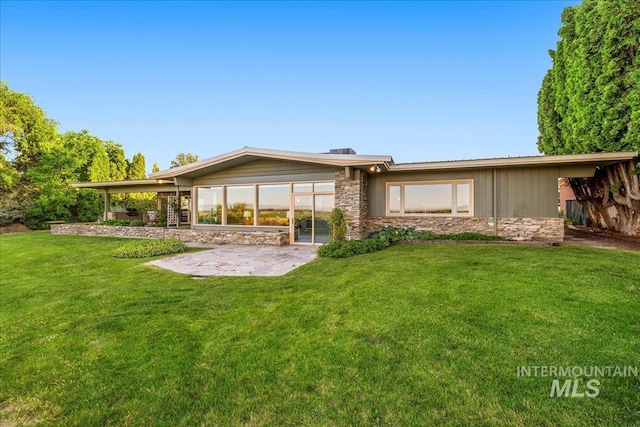 2401 Terrace Dr, Caldwell, ID 83605 - rear view of property featuring stone siding, a patio, and a yard