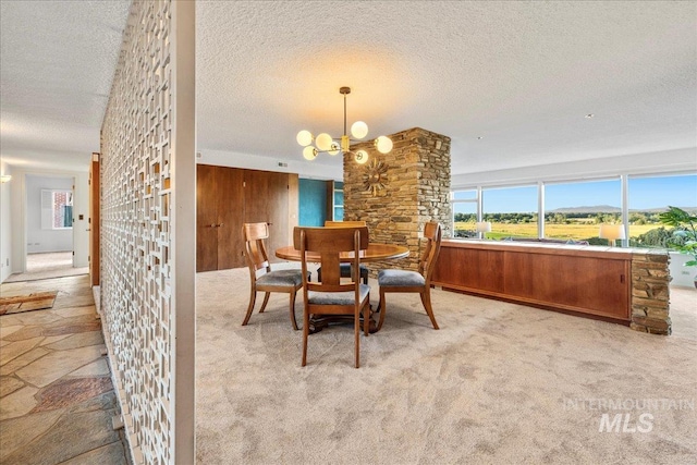 2401 Terrace Dr, Caldwell, ID 83605 - dining space with a textured ceiling, a chandelier, and carpet floors