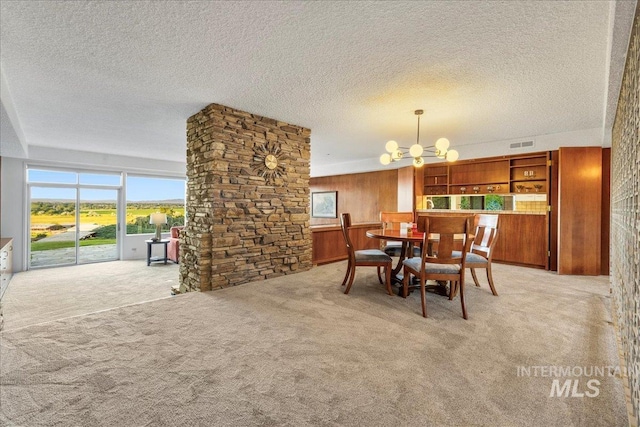 2401 Terrace Dr, Caldwell, ID 83605 - carpeted dining space with healthy amount of natural light, a chandelier, a textured ceiling, and wooden walls