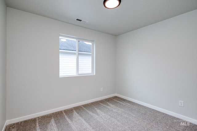 unfurnished room featuring visible vents, baseboards, and carpet floors