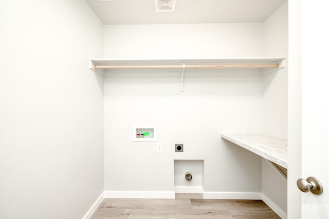 laundry room with laundry area, hookup for an electric dryer, light wood-type flooring, visible vents, and hookup for a washing machine