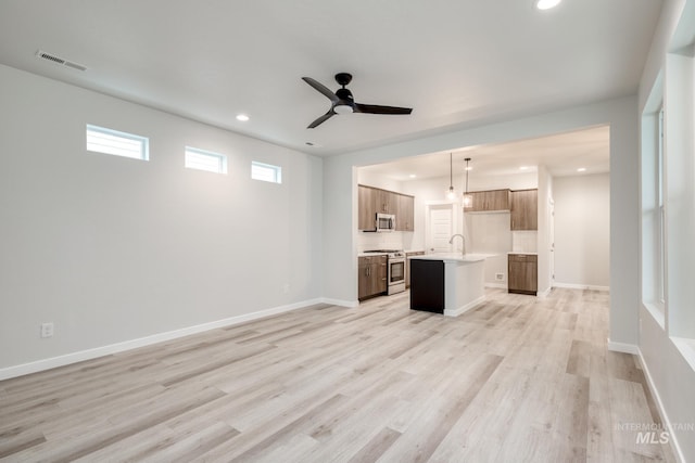 unfurnished living room featuring a ceiling fan, light wood finished floors, recessed lighting, and visible vents