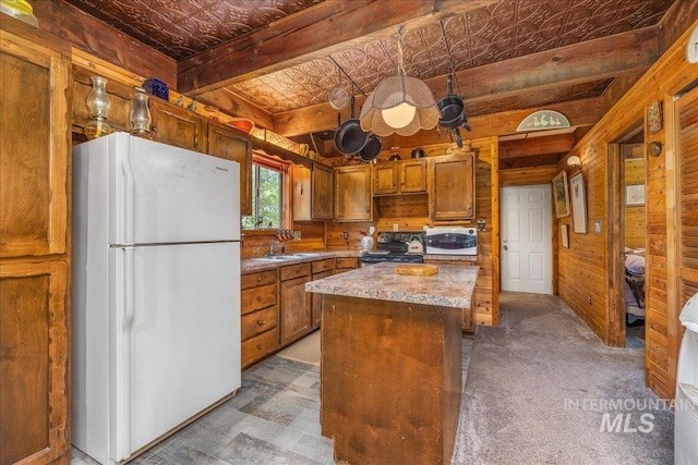 kitchen with brown cabinets, wooden walls, white appliances, an ornate ceiling, and a kitchen island
