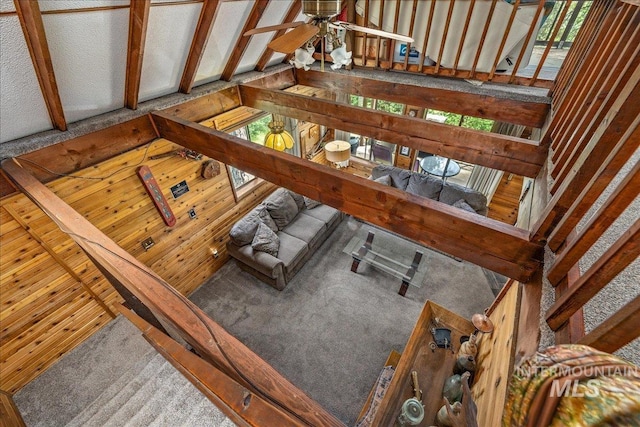 living room featuring carpet floors, a ceiling fan, and a wealth of natural light