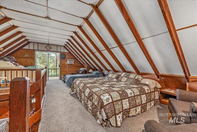 carpeted bedroom with lofted ceiling, wood walls, and a wall mounted air conditioner