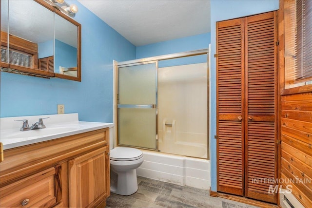 full bathroom featuring vanity, a closet, shower / bath combination with glass door, and toilet