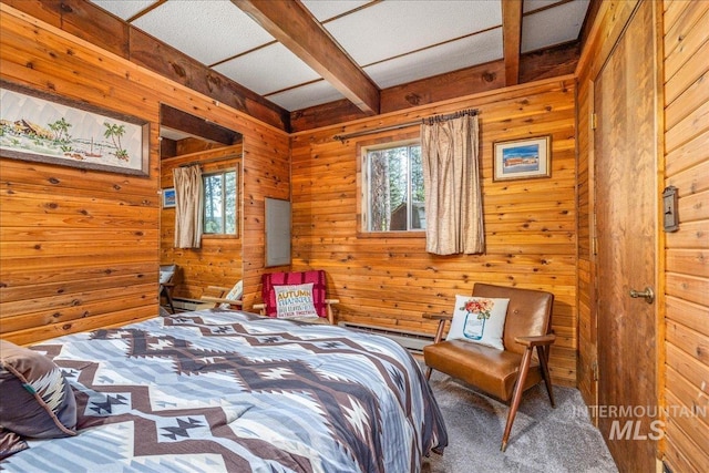 bedroom with a baseboard heating unit, wooden walls, carpet floors, and beam ceiling
