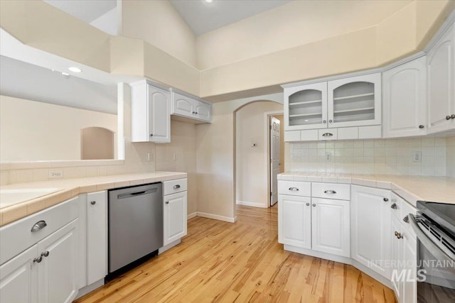 3314 S Raintree, Nampa, ID 83669 - kitchen featuring appliances with stainless steel finishes, glass insert cabinets, light wood-style floors, white cabinets, and a high ceiling